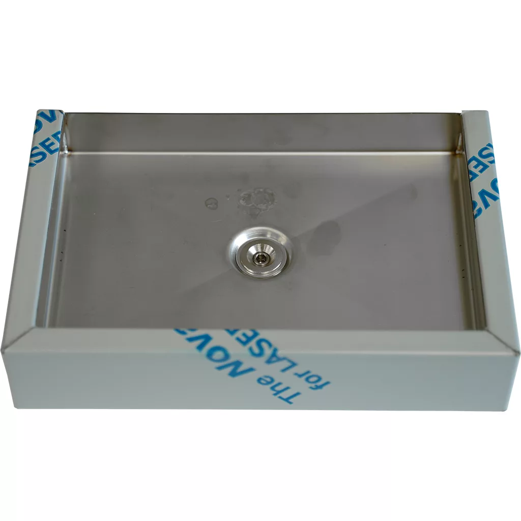 The Bezzera 5340510 Drip Tray is a rectangular stainless steel tray with a central drain, viewed from above. Blue protective film can be seen on the edges of the tray’s frame. © 2025 1st-line.com