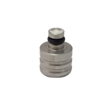 The CaffeMotive FMTAP0001X76 Spout Cap is a small, cylindrical metal fitting with a groove and black rubber O-ring near the top, ideal for CaffeMotive machines. Shown against a white background. © 2025 1st-line.com