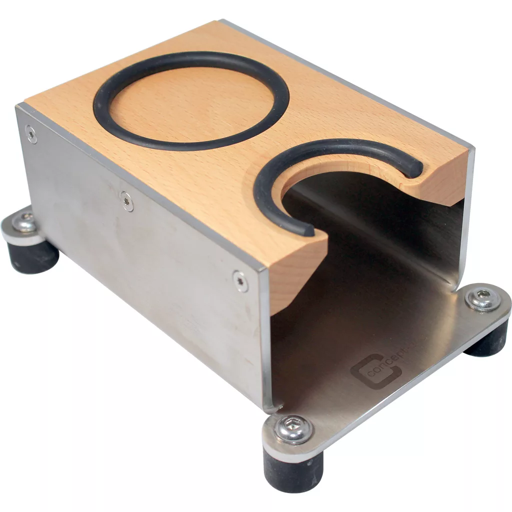 The DISCONTINUED Concept Art Wood Tamping Station features wood and metal construction, rubber-lined circular and semicircular grooves for secure holding, and four black rubber feet for stability. © 2025 1st-line.com