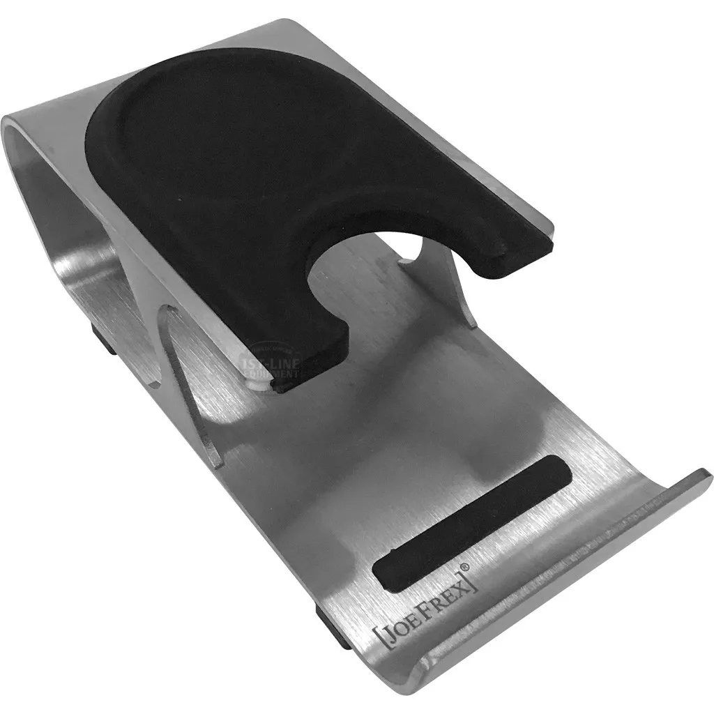 The DISCONTINUED Joe Frex Professional Metal Tamping Station with Tamping Stand features stainless steel construction, a black rubber insert, and a U-shaped cutout to securely hold your coffee tamper. © 2025 1st-line.com