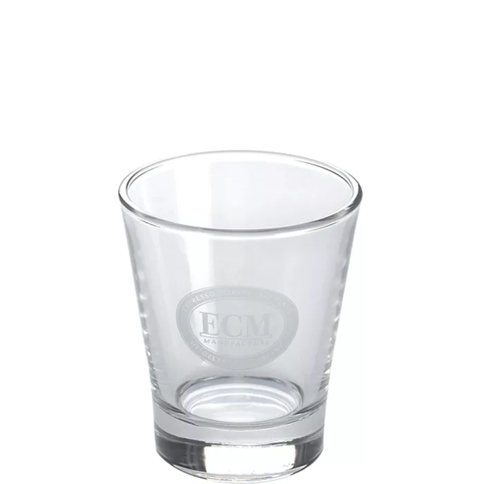 The ECM Espresso Shot Glass (~3 fl oz), featuring a circular etched logo and letters on the front, is shown against a white background. © 2025 1st-line.com