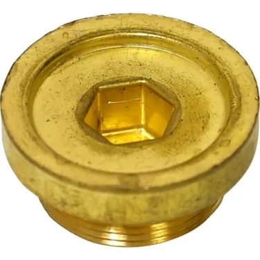 The Elektra 00026014 Boiler HX Connection Nut is a round brass nut with a central hexagonal socket, showing visible scratches and wear. © 2025 1st-line.com