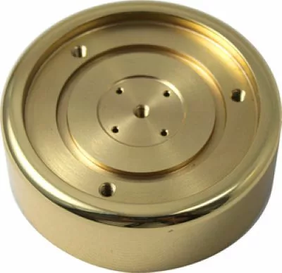 The Elektra 02151019 Brass Grouphead Bell is a gold-colored, polished metal disc with raised concentric design and symmetrically spaced holes—perfect as a replacement component for Elektra espresso machines. © 2025 1st-line.com