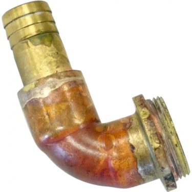 The Elektra 02703011 90 Degree Pipe Connector - Belle Epoque is a brass plumbing elbow fitting with a threaded end, visible solder marks, and signs of use and tarnish. © 2025 1st-line.com