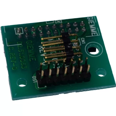 The Elektra 04062035 Socket/Connector Card - Nino is a small green PCB with gold and black pin headers, labeled GIEMME, various component labels, multiple solder points, and a large mounting hole. © 2025 1st-line.com