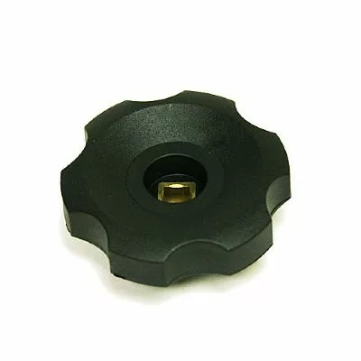 The Fiorenzato A1600004 Steam Knob is a black, round plastic knob with a scalloped edge and a central square brass insert, shown on a white background. © 2025 1st-line.com