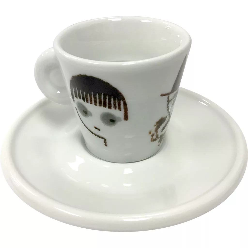 The Miscela dOro Espresso Cup & Saucer - 2 fl oz features a white ceramic cup with a handle, a cartoon-style face and straight black hair, and comes with a matching saucer—ideal for savoring your favorite espresso. © 2025 1st-line.com