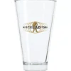 The Miscela dOro Latte Glass is a clear coffee glass with a gold Miscela dOro logo and an illustration of a walking figure carrying a large sack. © 2025 1st-line.com