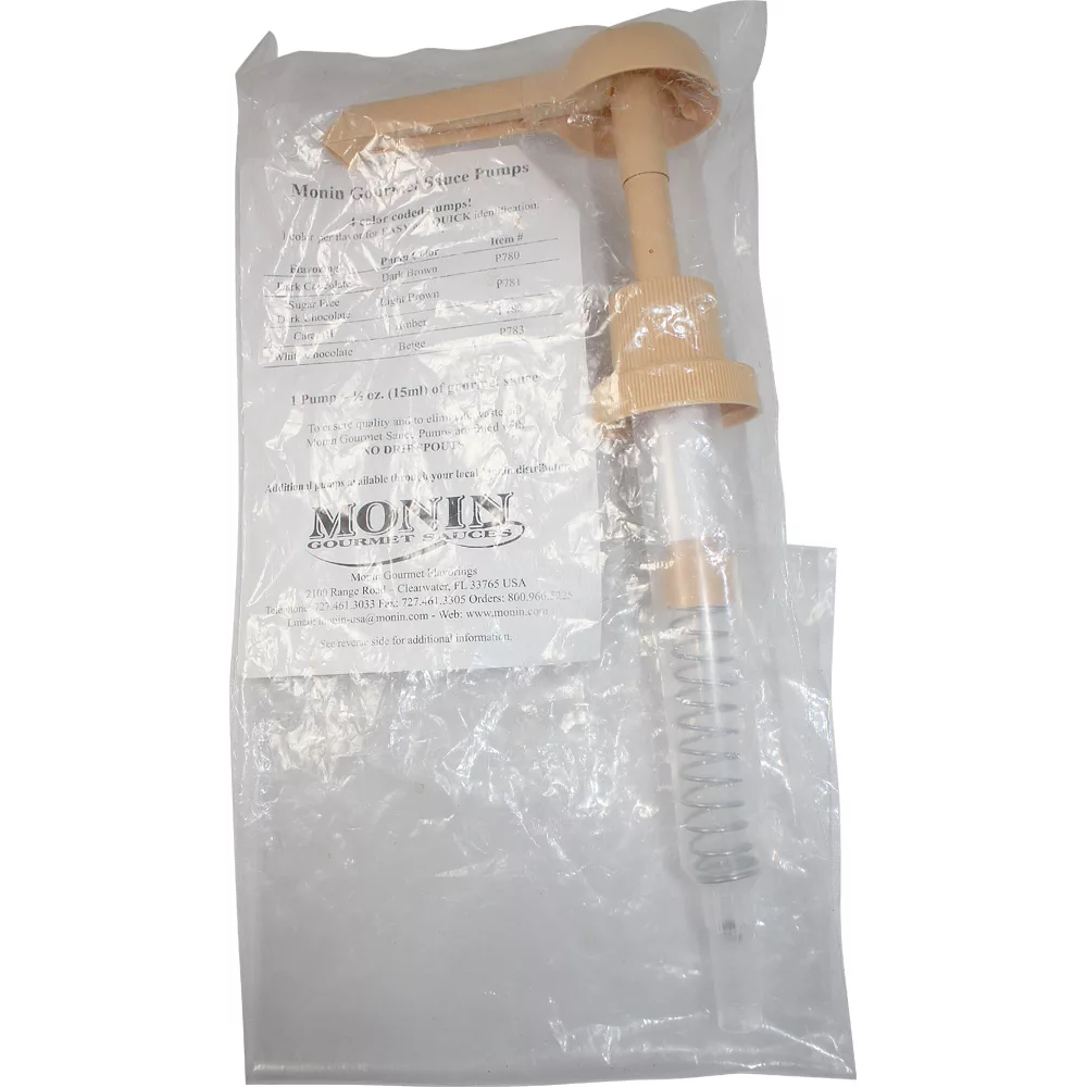 The Monin Pump - caramel is sealed in transparent plastic packaging with visible printed instructions in the background; it has a beige and clear design. © 2025 1st-line.com