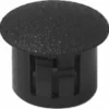 The Rancilio 38221007 Doser Tank/Reservoir Cap is a black plastic hole plug with a textured, rounded top and slotted sides for secure panel or surface installation. © 2025 1st-line.com