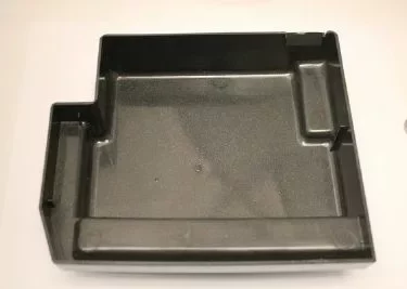 The Saeco Drip Tray Base for Royal Digital/Professional and Magic Deluxe is a black plastic, rectangular tray with raised edges and multiple compartments, including a left-side extension, shown on a plain white background. © 2025 1st-line.com