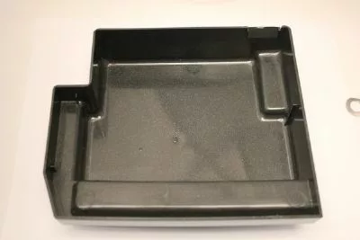 The Saeco Drip Tray Base for Royal Digital/Professional and Magic Deluxe is a black plastic, rectangular tray with raised edges and multiple compartments, including a left-side extension, shown on a plain white background. © 2025 1st-line.com