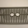 The Saeco Drip Tray Grill for Royal Digital/Professional and Magic Deluxe features parallel bars and two circular openings in the center, displayed on a plain light background. © 2025 1st-line.com