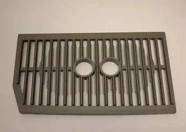 The Saeco Drip Tray Grill for Royal Digital/Professional and Magic Deluxe features parallel bars and two circular openings in the center, displayed on a plain light background. © 2025 1st-line.com