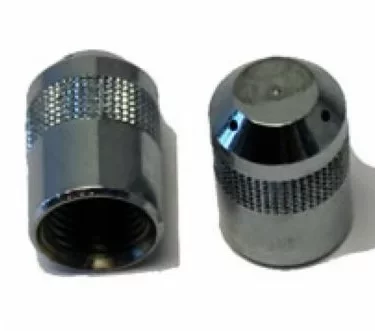 Two metallic knurled nuts from the Rancilio 23119023 Steam Wand Tip - 3 hole for Rancilio commercial models are shown, one upright and one on its side, both with textured surfaces for improved grip against a white background. © 2025 1st-line.com