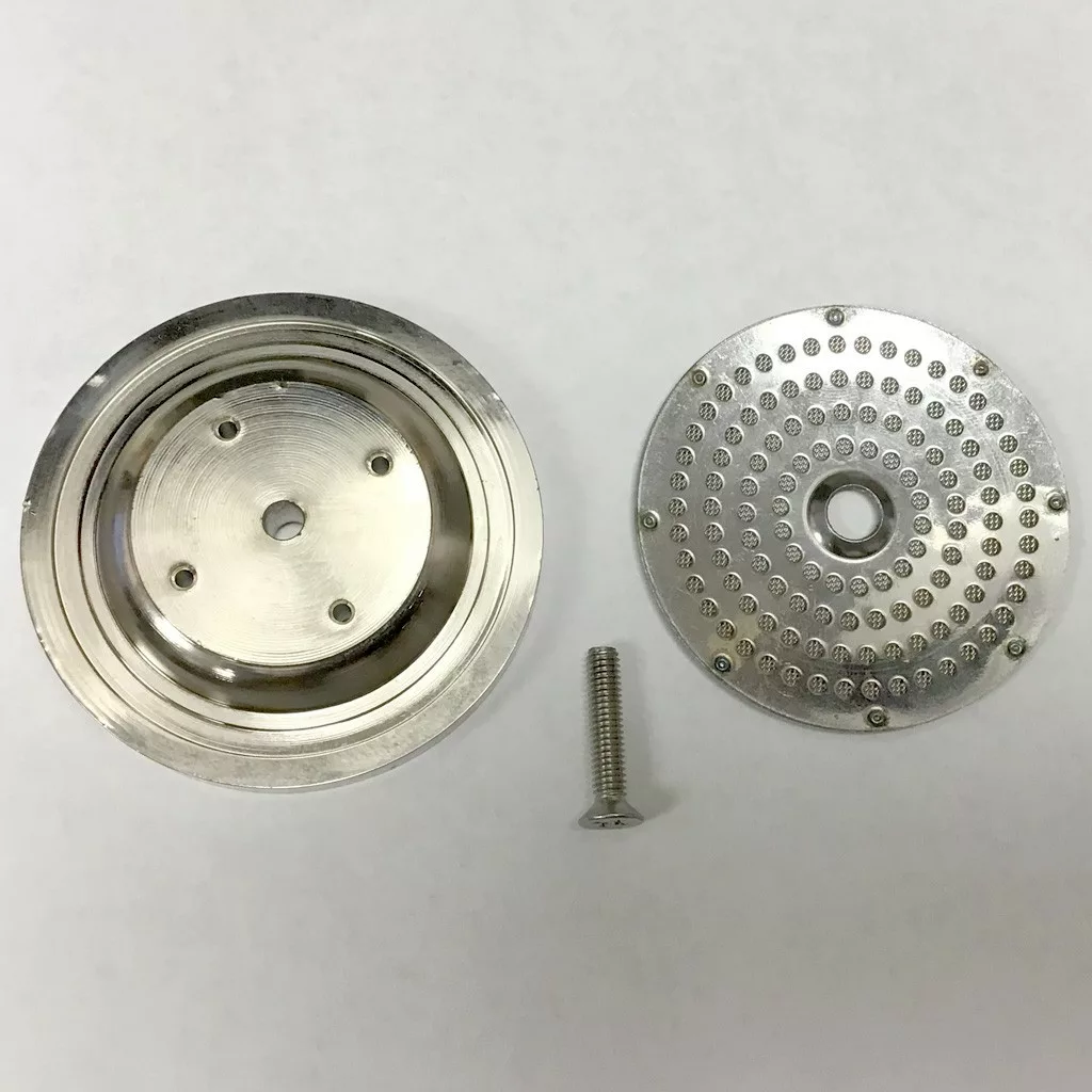 Two round metal parts from the DISCONTINUED Ascaso KIT..1 Pod to Ground Conversion Kit and a screw lie on a white surface; the left piece has three holes, while the right one has small holes surrounding a central opening. © 2025 1st-line.com