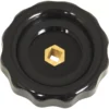 A black, round plastic VBM MANPRUVAACRE Steam/Water Rotary Knob with a scalloped edge and central brass hexagonal opening, viewed from above on a white background. © 2025 1st-line.com