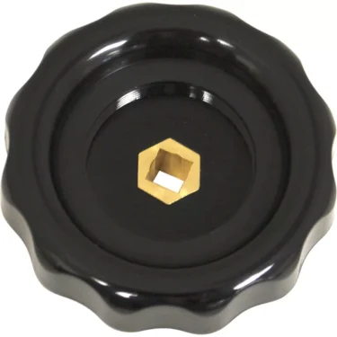 A black, round plastic VBM MANPRUVAACRE Steam/Water Rotary Knob with a scalloped edge and central brass hexagonal opening, viewed from above on a white background. © 2025 1st-line.com