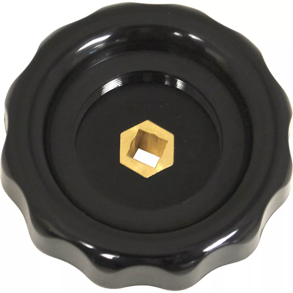 A black, round plastic VBM MANPRUVAACRE Steam/Water Rotary Knob with a scalloped edge and central brass hexagonal opening, viewed from above on a white background. © 2025 1st-line.com