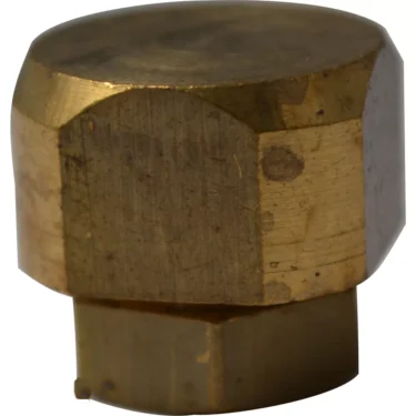 A close-up of a brass hexagonal bolt cap with a flat top and tarnish marks, featured as part of the Grimac 3510830 Union Elbow 1/4F for Ulka Type Pump. © 2025 1st-line.com
