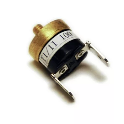A close-up of a small electronic component, the DISCONTINUED SEE CODE I..374 Ascaso I374 100º Thermostat, featuring a gold-colored top, white label marked T1/11 100, and two metal terminals on its black base. © 2025 1st-line.com