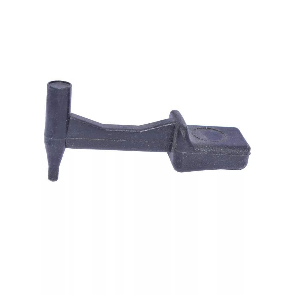 A small black plastic Isomac 000420 Catch Set for Granmacinino, featuring a flat rectangular end, raised central section, and cylindrical side protrusion, isolated on a white background. © 2025 1st-line.com