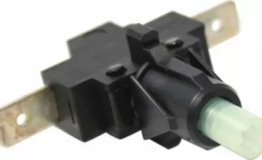 Close-up of an Ascaso MI.123 On/Off Switch—compatible with I-1, I-2, I-Mini, and I-Steel—in black plastic with a green plunger and two metal terminals. © 2025 1st-line.com