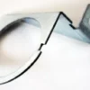 The Ascaso I..672 Gauge Holding Bracket features a circular opening and bent arm, perfect for mounting or supporting cylindrical items like pipes or sensors—ideal for Ascaso applications. © 2025 1st-line.com