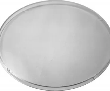 The Ascaso MI.112 Bean Hopper Cover is a clear, round, flat glass disc with smooth edges, shown on a white background. © 2025 1st-line.com