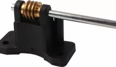 The Ascaso MI...3 Stepless Worm Gear Drive Assembly features a black plastic and metal linear rail shaft support, a mounted brass helical gear, and a horizontal metal rod running through the unit. © 2025 1st-line.com