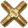 The Bezzera 7304001TR Union Elbow 1/8 G is a brass X-shaped fitting with four threaded ends and “SERTO” embossed in the center—ideal for Bezzera or Union Elbow uses. © 2025 1st-line.com