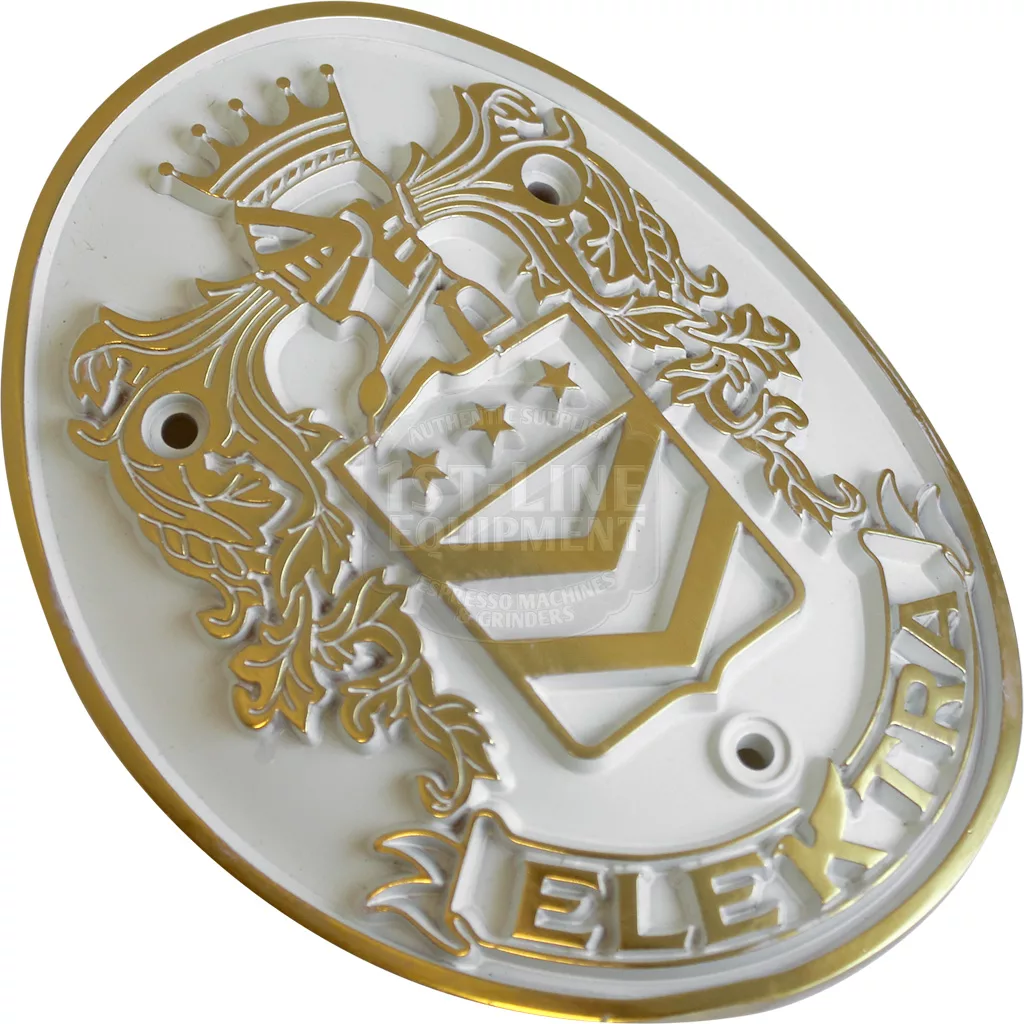 The Elektra 02858062 Emblem - Belle Epoque is a gold and white oval emblem with a crowned knight’s helmet, shield with stars and stripes, ornate foliage, “Elektra” at the bottom, and three mounting holes. © 2025 1st-line.com