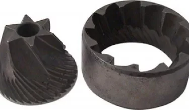 The Lelit MC311 38mm Conical Grinding Burrs—a dark metal set with one angled-ridge cone and one grooved ring—are displayed side by side on a white background. © 2025 1st-line.com