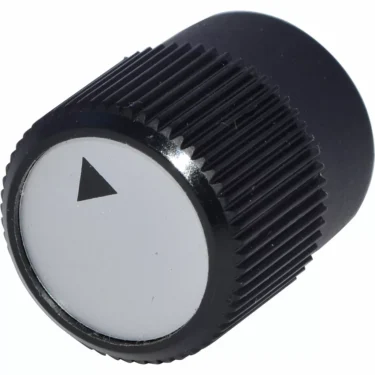 The Lelit MC334 Adjustment Knob is black and cylindrical with a ridged grip and a white top featuring a black outward-pointing triangular arrow. © 2025 1st-line.com