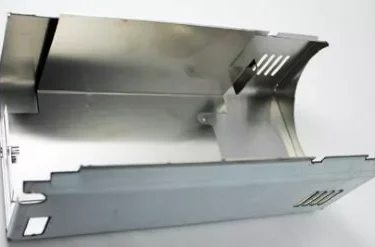 The Rancilio 10781351 Rear Body Panel - old version is a rectangular metal enclosure with cutouts, ventilation slots, a shiny surface, and open sides. It is pictured against a plain white background. © 2025 1st-line.com