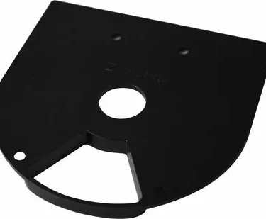 The Rancilio 38123030 Bottom Doser Cover is a black, semi-circular plastic part with a central round hole, two smaller upper holes, and an indented flat bottom edge with two cutouts. © 2025 1st-line.com