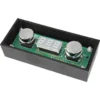 The VBM ELETPULDISPDM PID Touchpad Display is a compact electronic device with a digital screen and two round metal sensors, mounted on a green circuit board within a black rectangular case. © 2025 1st-line.com