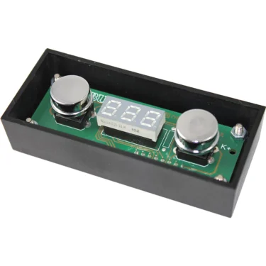The VBM ELETPULDISPDM PID Touchpad Display is a compact electronic device with a digital screen and two round metal sensors, mounted on a green circuit board within a black rectangular case. © 2025 1st-line.com