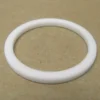 The VBM GUARCALDOM Heating Element Gasket, a white circular washer-like ring, lies flat on a plain brown surface—perfect as a replacement gasket for VBM machines. © 2025 1st-line.com