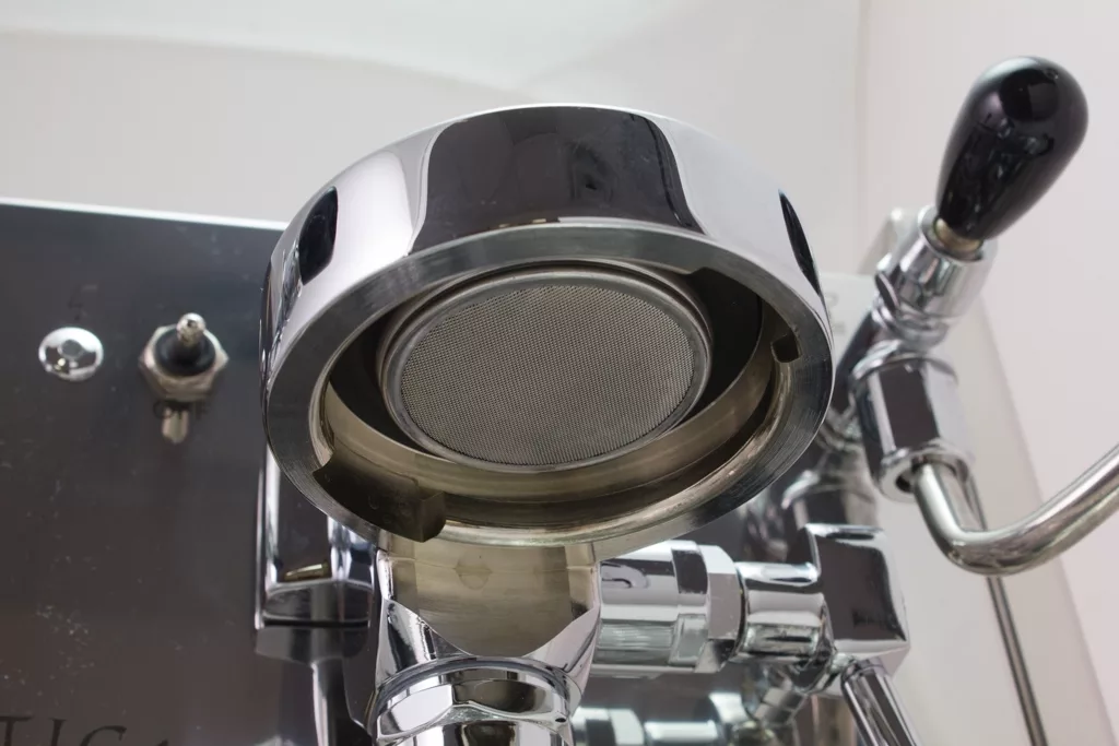Close-up view of the group head and portafilter area on the Bezzera Mitica V2 HX Espresso Machine, featuring its metal filter and polished chrome surfaces. © 2025 1st-line.com