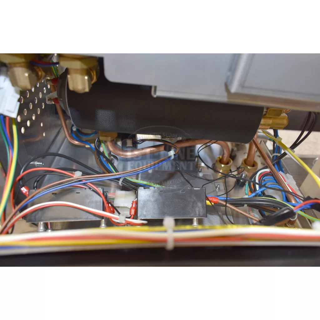 Close-up view of the interior of the Bezzera Matrix MN V2 Dual Boiler Espresso Machine, showing an intricate arrangement of wires, metal components, and connectors—highlighting its complex engineering. © 2025 1st-line.com