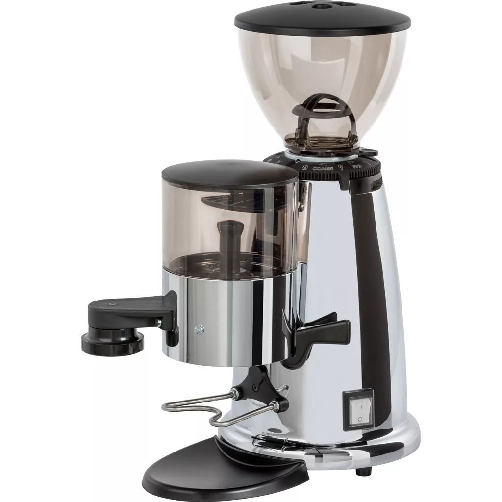 The discontinued Macap M42 Stepless Doser Espresso Coffee Grinder features a silver finish, large transparent bean hopper, smaller front container, stepless doser, portafilter holder, and control switches at the base. © 2025 1st-line.com