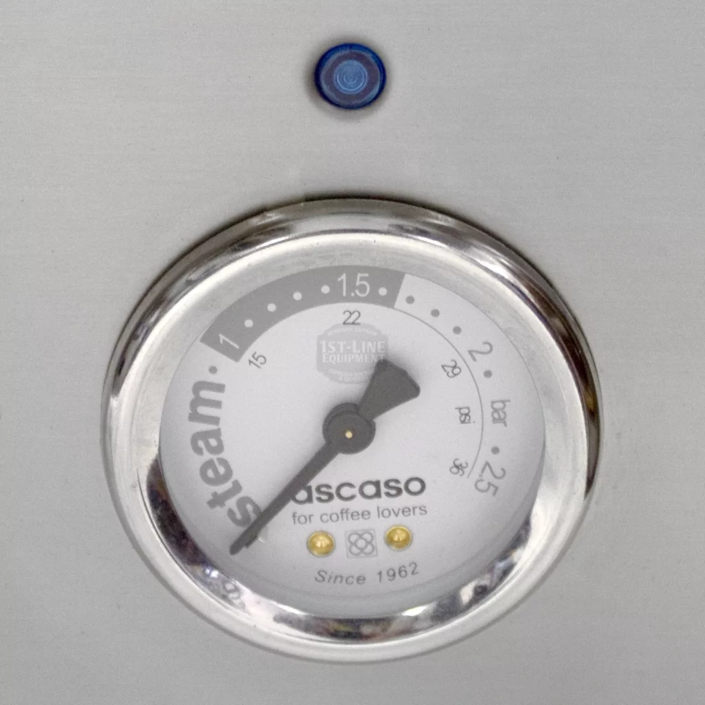 A close-up of the steam gauge (0–2.5 bar) and blue indicator light on a SOLD RETURNED AND REFURBISHED Ascaso Bar 2 Group Espresso Machine, 110V direct connect with vibration pumps—ideal for coffee lovers seeking quality. © 2025 1st-line.com