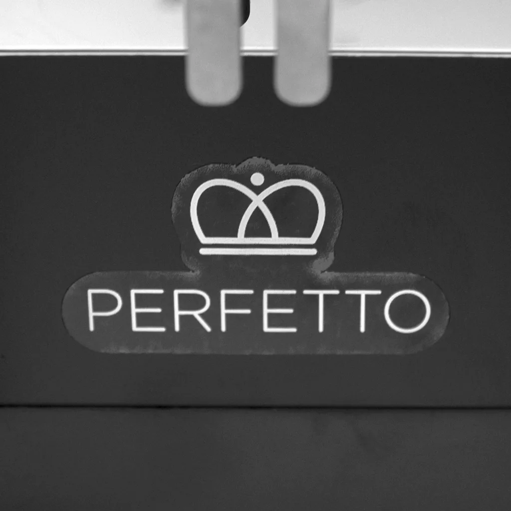 A black and white image displays a PERFETTO label with a crown logo above, set against a dark background—reflecting the refined style of the Eureka Mignon Perfetto Espresso Coffee Grinder. © 2025 1st-line.com