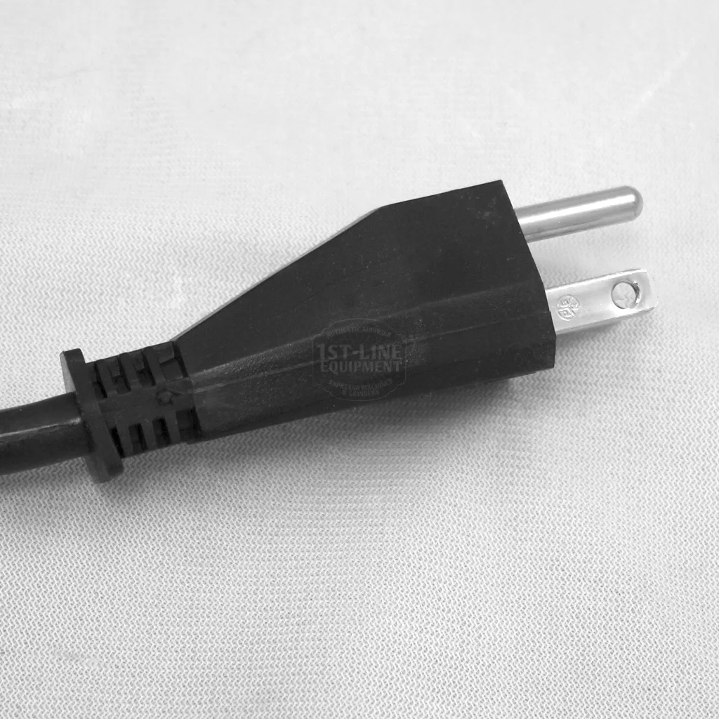 A close-up of a black, two-prong electrical power plug laying on a light-colored fabric surface, often seen while performing Rancilio Silvia maintenance or accessing the inside of your Rancilio Silvia espresso machine. © 2025 1st-line.com