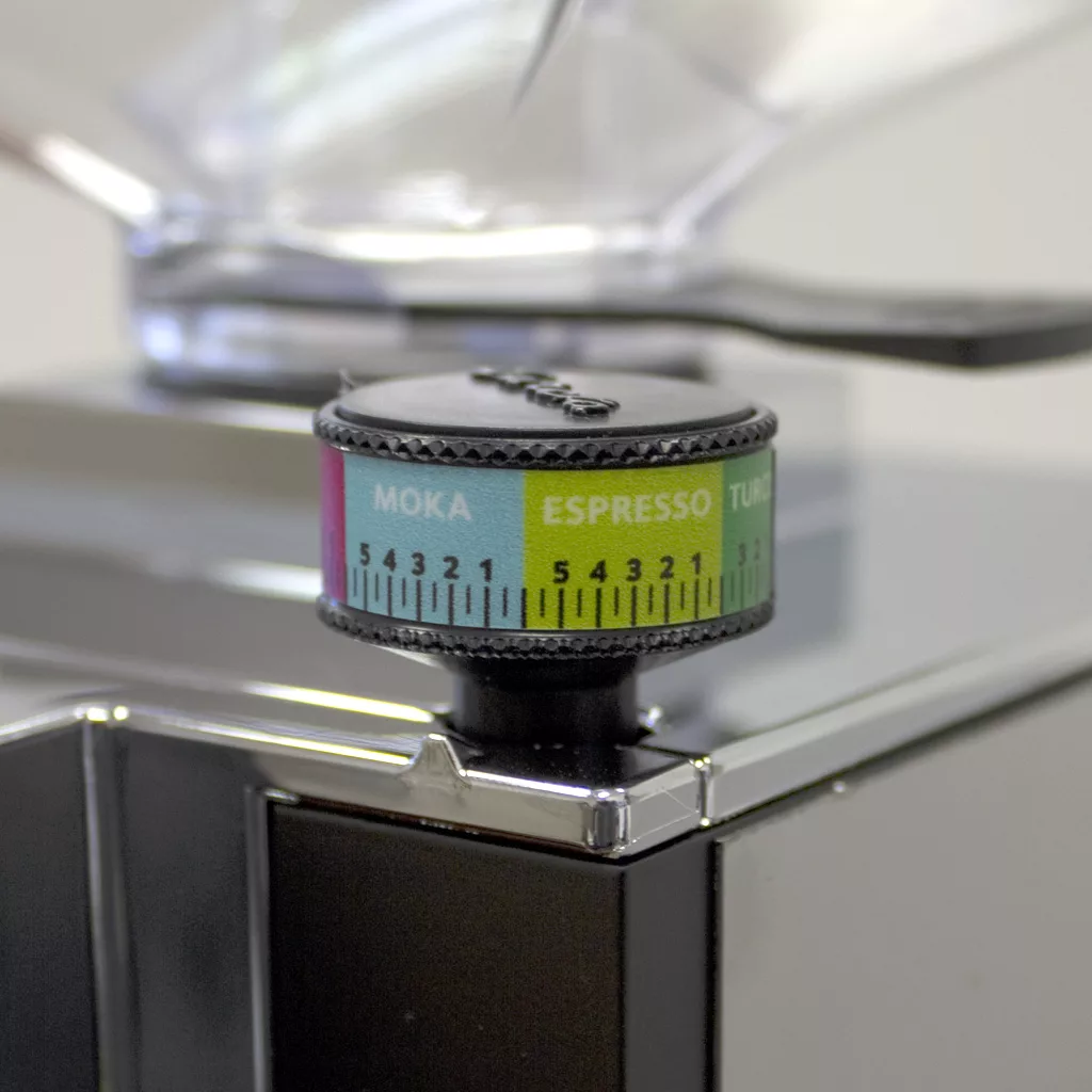 Close-up of the Eureka Mignon Perfetto Espresso Coffee Grinder’s adjustment dial, showing colored sections for Moka, Espresso, and Turkish with numbered grind size scales on a metallic surface. © 2025 1st-line.com