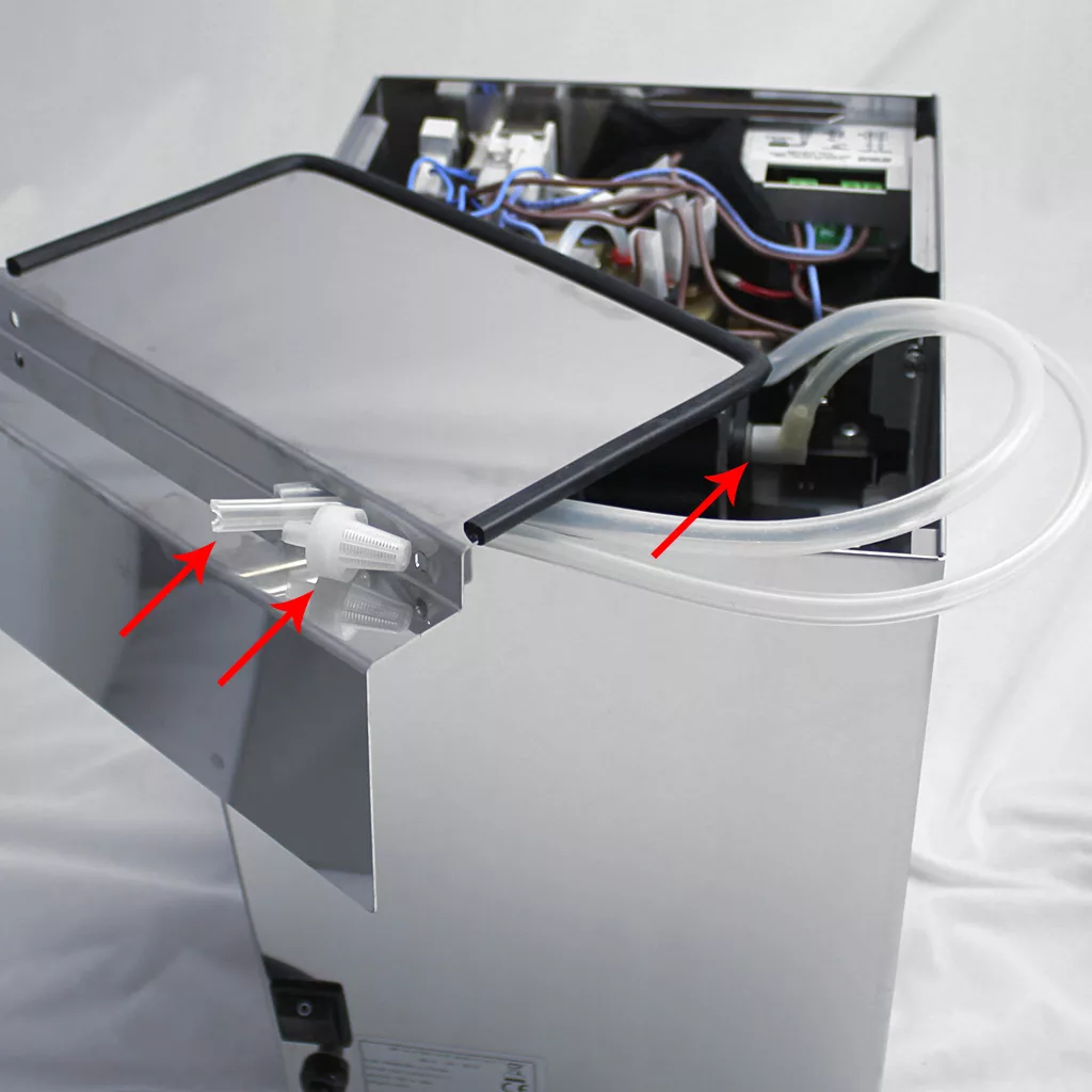 A partially opened Lelit PL41TEM espresso machine with exposed wires and circuit boards; three red arrows point to a white plastic valve, transparent tubing, and an internal connection inside the Anna device. © 2025 1st-line.com