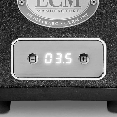 Close-up of the ECM S-Automatik 64 Espresso Grinders control panel, featuring a digital display at 03.5 with plus and minus buttons and an ECM Manufacture Heidelberg Germany label above. © 2025 1st-line.com