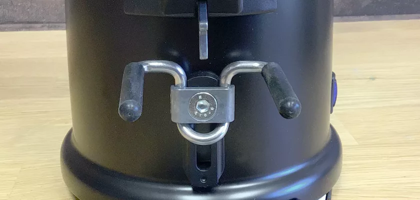 Close-up of the Elektra MSD Espresso Coffee Grinder with two horizontal metal handles and a central bolt on a wooden surface. Its sturdy, rounded base ensures reliable performance for espresso enthusiasts. © 2025 1st-line.com