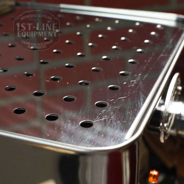 Close-up of the RETURNED & REFURBISHED - ECM Casa V Espresso Machine (C102) drip tray with evenly spaced holes reflecting light; the 1st-Line Equipment logo is faintly visible, showcasing this elegant refurbished model. © 2025 1st-line.com